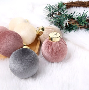 Close-up of 8cm striped velvet Christmas balls in soft grey and pink with gold caps