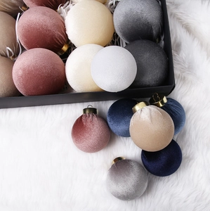 Close-up of luxury velvet Christmas ornaments with metal rings in a gift box