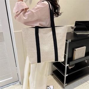 Fashionable straw tote bag with black canvas straps and large capacity for women