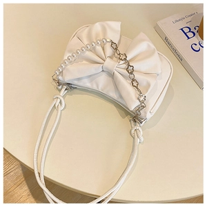 White crescent underarm bag with large bow and pearl flower metal chain detail