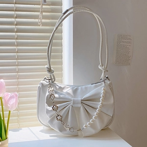 White faux leather shoulder bag featuring a large bow design and pearl flower chain