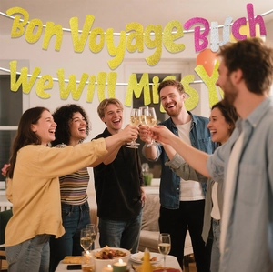 Glittery 'Bon Voyage Bitch' and 'We Will Miss You' party banners for retirement farewell