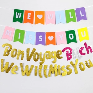 Close-up of glittery gold and colorful felt retirement party banners with heart details
