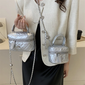 Silver quilted mini vanity bag with chain strap and flower charm in two sizes