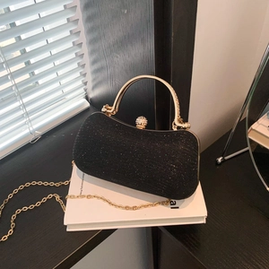 Elegant black glitter evening clutch bag with gold round handle and diamond clasp lock