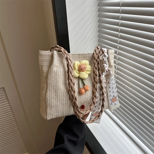 Straw woven handbag in beige with yellow flower decor and printed silk scarf for summer