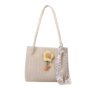 Chic beige straw tote bag with yellow floral charm and printed silk scarf on handle