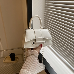 White minimalist mini flap handbag with unique curved handle and metal chain strap