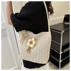 Détail d'un sac cabas en tricot avec fleur 3D et nœud en dentelle sur un mannequin