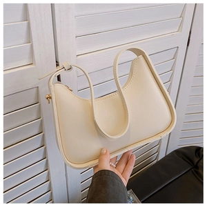 Detail view of cream hobo bag showing high-quality PU leather texture and gold hardware