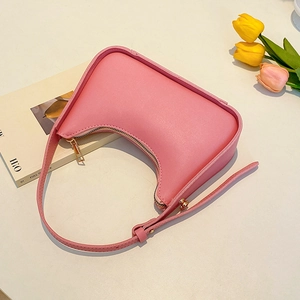 Pink crescent hobo bag in smooth faux leather with gold hardware and shoulder strap
