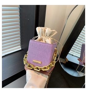 Detail of purple woven box bag with cream drawstring lining and gold chain handle
