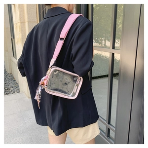 Detail of pink transparent PVC crossbody bag with wide strap and floral silk scarf detail
