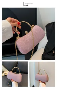 Detail of pink sequin clutch bag with golden metal handle and diamond-encrusted clasp