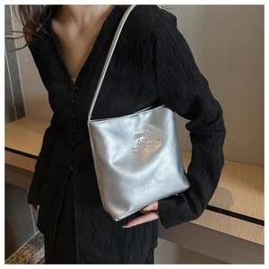 Shoulder bag detail with metallic silver finish and stay and optimism text decoration