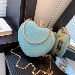 Glittering light blue heart-shaped evening clutch bag with gold chain and crystal clasp