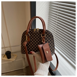 Detail view of a vintage monogram dome handbag with a small detachable charm bag