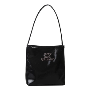 Fashionable black glossy bucket bag with pink embroidery on a long shoulder strap