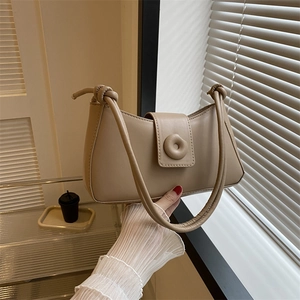 Minimalist beige half-moon crossbody bag with knot strap and circular metal buckle