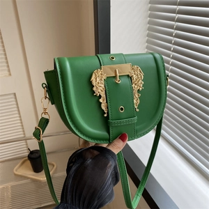 Fashionable dark green saddle bag with gold baroque buckle and adjustable strap