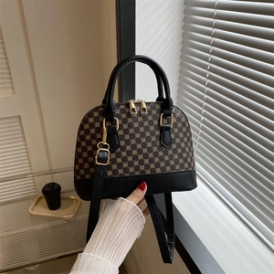 Vintage monogram handtas met bruin patroon en zwart lederen contrasterende accenten