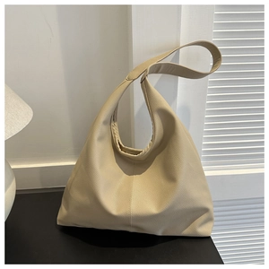 Detail of minimalist cream PU leather hobo tote showing large capacity and soft texture
