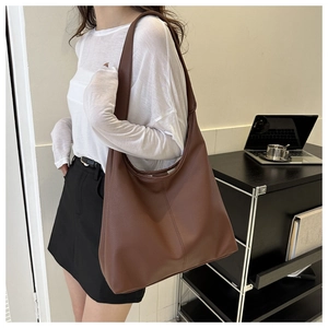 Brown large capacity PU leather tote bag shown on model in an office setting