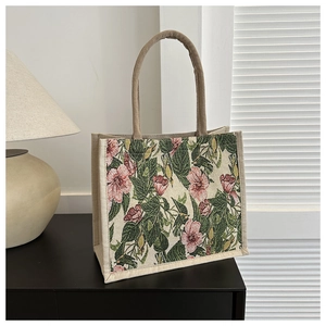 Detailed close-up of vintage pink floral linen tote bag with khaki braided handles