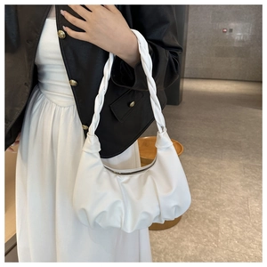 Detail of white pleated dumpling bag with chic woven strap and smooth zipper finish