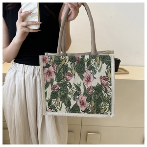 Detail of floral tapestry tote bag with pink flowers and durable rope handles for daily use
