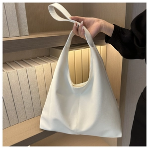 Detail of a beige PU leather hobo bag showing the high-quality lychee grain texture