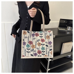 Close-up of a floral print linen tote bag featuring retro colorful flower patterns