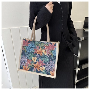 Close-up of vibrant floral print on large linen tote bag with woven handles