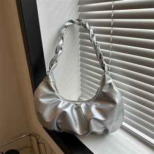 Silver metallic pleated crescent shoulder bag with a unique twisted handle and zipper
