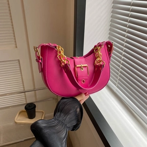 Hot pink crescent underarm bag with gold chain strap and metallic buckle closure