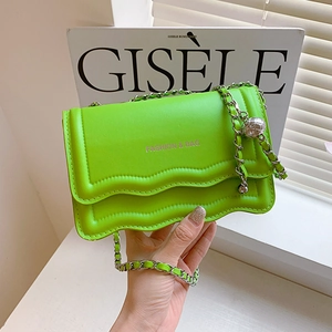 Neon green leather shoulder bag with silver chain strap and decorative metallic ball charm