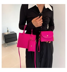 Detailed view of pink quilted three-piece handbag set featuring elegant gold hardware