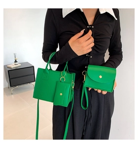 Detailed view of bright green quilted tote bag set with gold hardware on a model