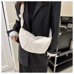 White quilted cloud bag with large wave stitching and knotted shoulder strap detail