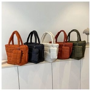 Quilted puffer tote bags in five colors featuring matching mini pouches and geometric stitching