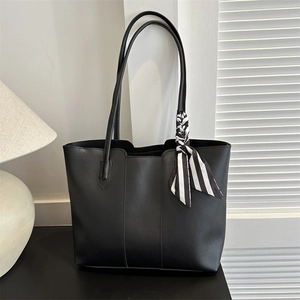 Elegant black leather tote bag with stylish striped scarf for women shoulder carry