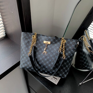 Classic patterned tote bag with golden chain straps and a signature deer pendant charm