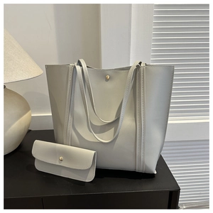 Detail view of large minimalist tote bag with matching pouch and golden magnetic closure