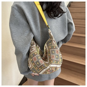 Detail of geometric ethnic pattern woven crossbody bag with colorful square patterns