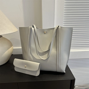 Minimalist light grey leather tote bag set with matching inner pouch and slim straps