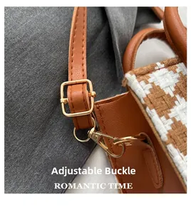 Detail of adjustable gold buckle on brown plaid crossbody bag strap