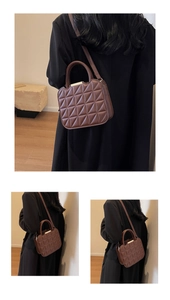 Detail of dark brown quilted crossbody bag with triangular stitching and gold metal accents