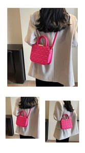 Detail of rose pink quilted mini crossbody bag featuring gold metal accents on handles