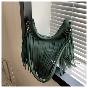Detailed close-up of dark green tassel shoulder bag with elegant gold zipper and hardware