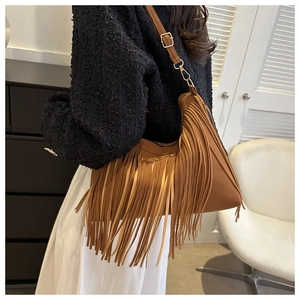 Detailed view of the brown fringe shoulder bag with long tassels and hobo style shape